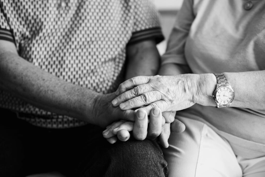 elderly people holding hands