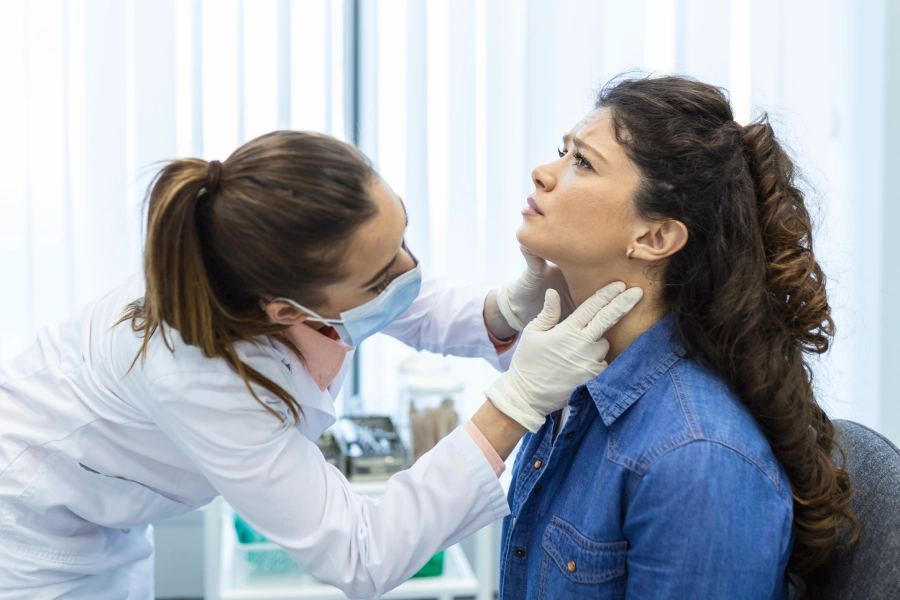 Doctor examining a patient's neck