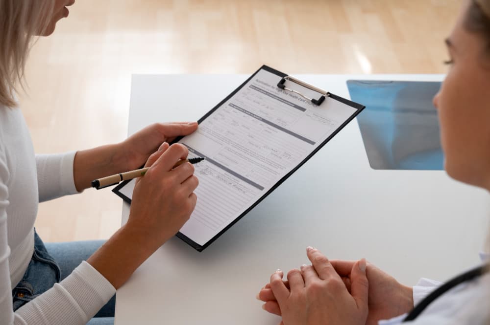 Clinical trial patient signing with the guide of a medical professional