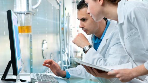 Two doctors analyzing the results on a PC